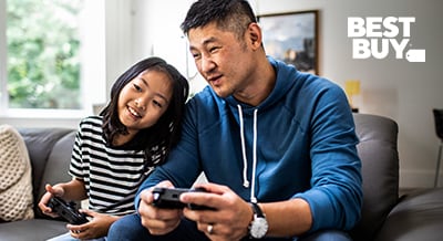 father and daughter playing a video game together