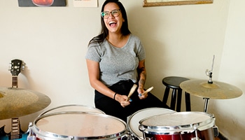  A woman playing the drums. 