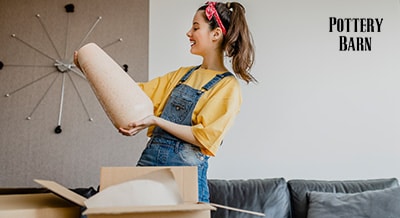 girl unboxing a piece of furniture in her apartment