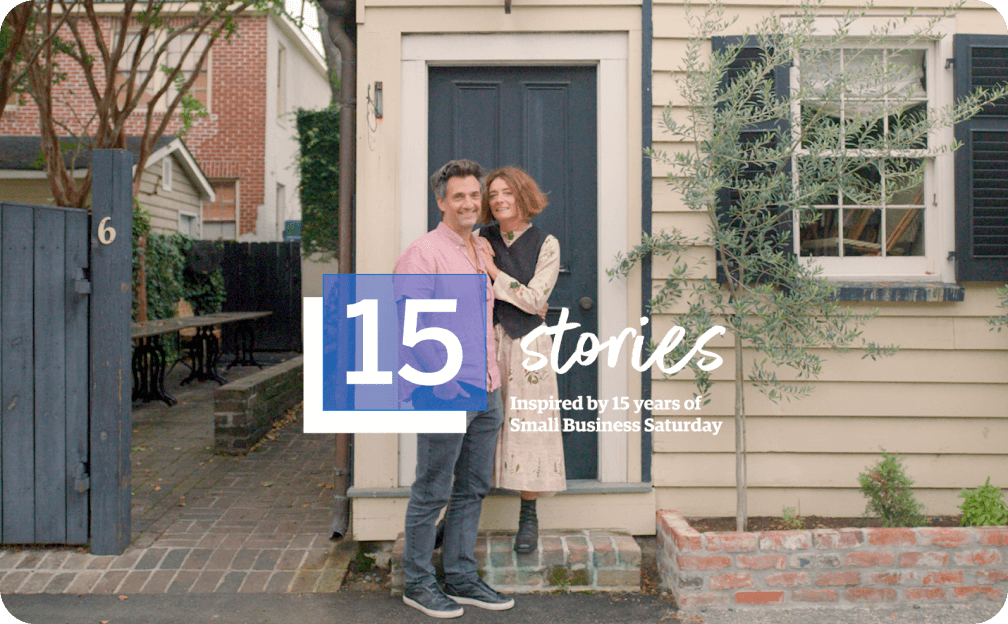 People posing in front of a home