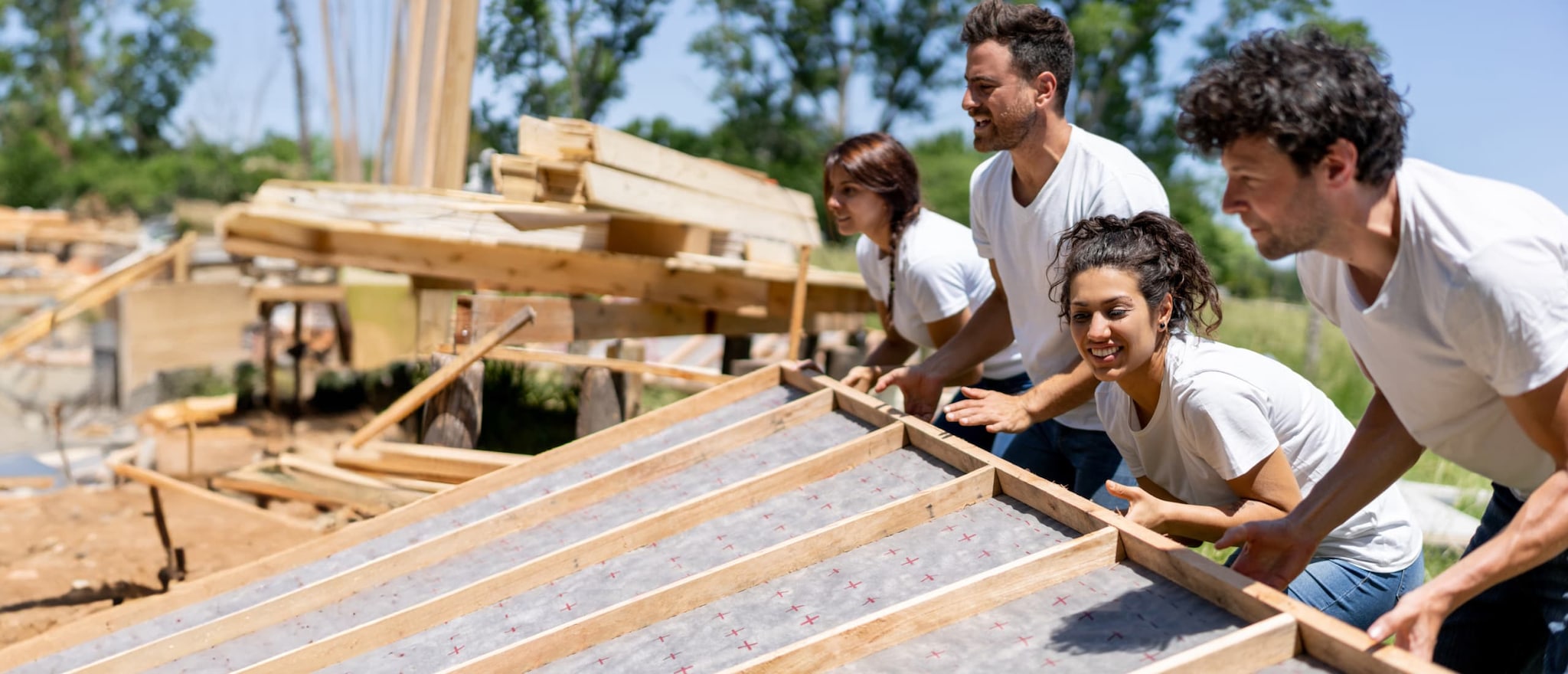 people lifting a wall frame