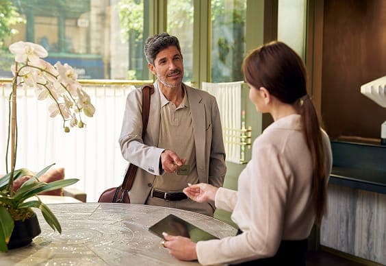 Person checking into hotel with luggage