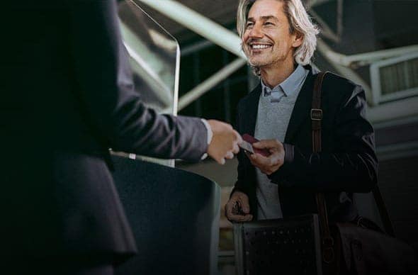 Person smiling in airport security with TSA logo