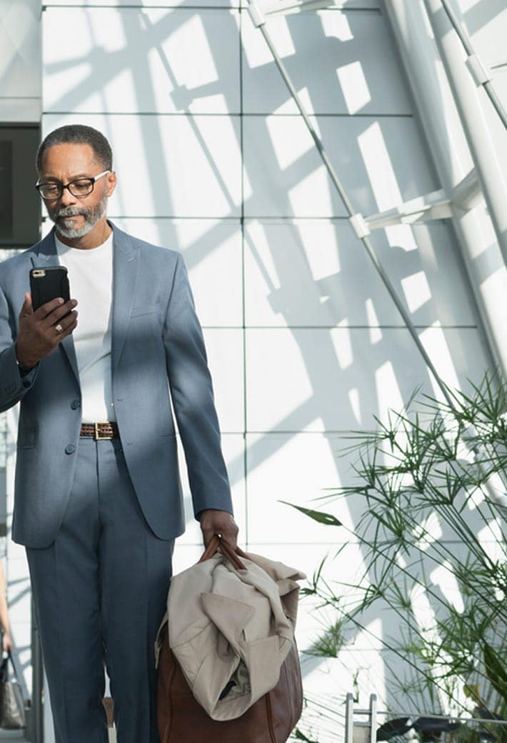 Person waiting in airport on their phone