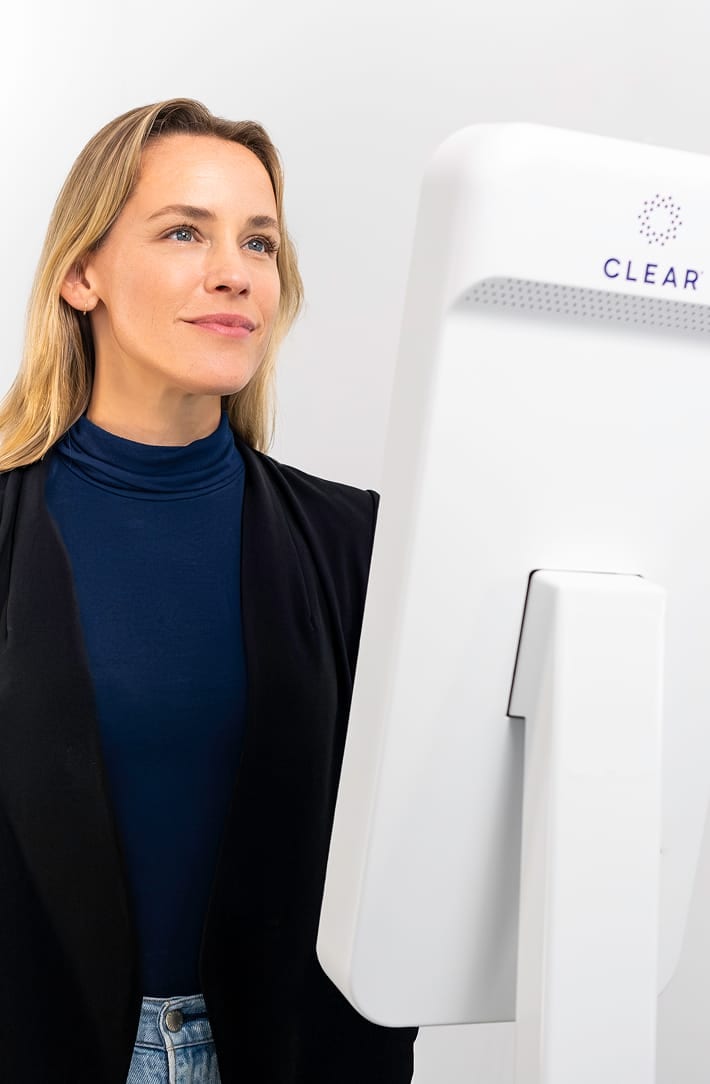 Person at a CLEAR Kiosk with the CLEAR logo