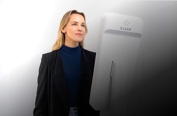 Person at a CLEAR Kiosk with the CLEAR logo