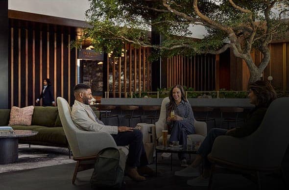 People enjoying a lounge with the GLC logo