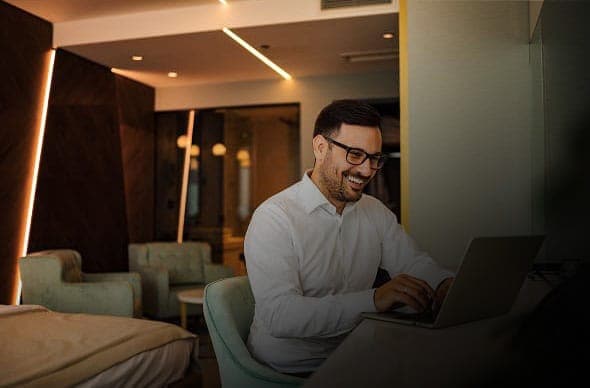 Person in a hotel room with Marriott Bonvoy logo