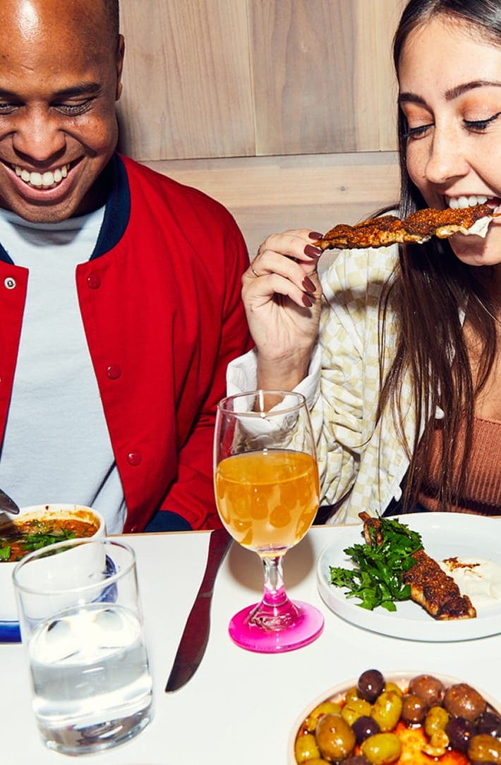 People enjoying dinner and drinks with the RESY logo