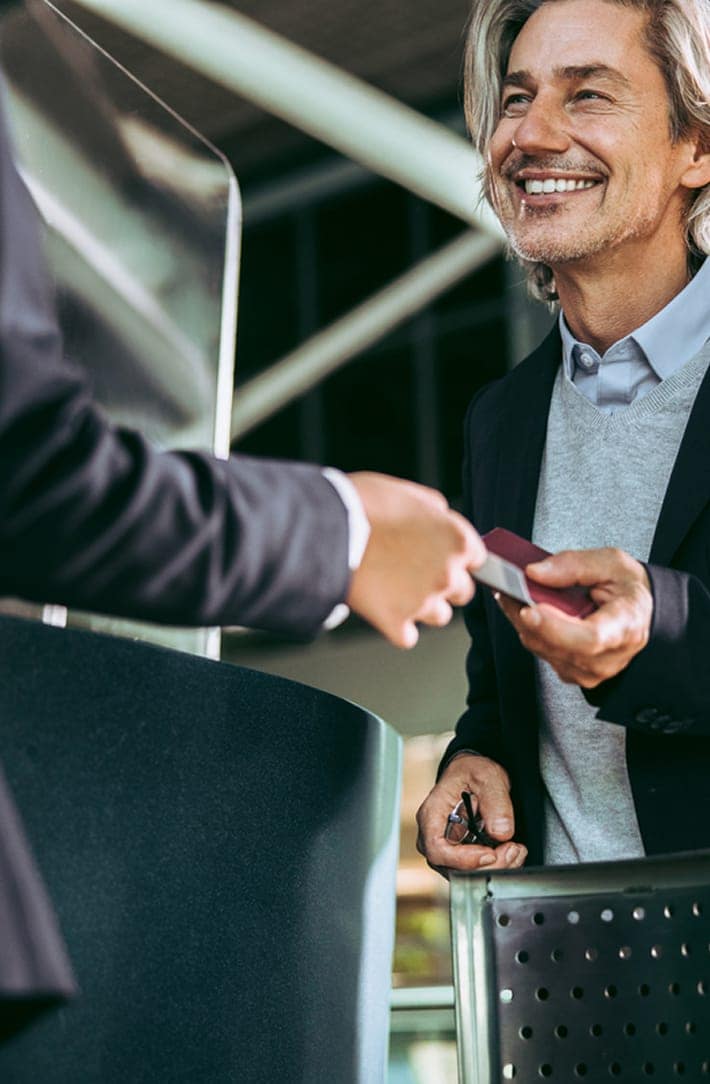 Person smiling in airport security with TSA logo