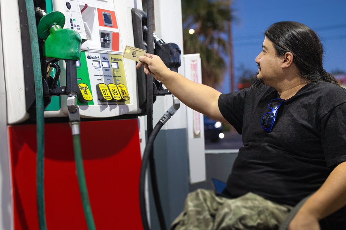 A person using his card at a gas pump