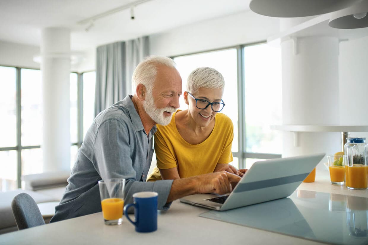 A retired couple discussing investment strategies with a financial adviser