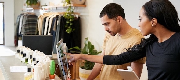 Business owner and employee using computer