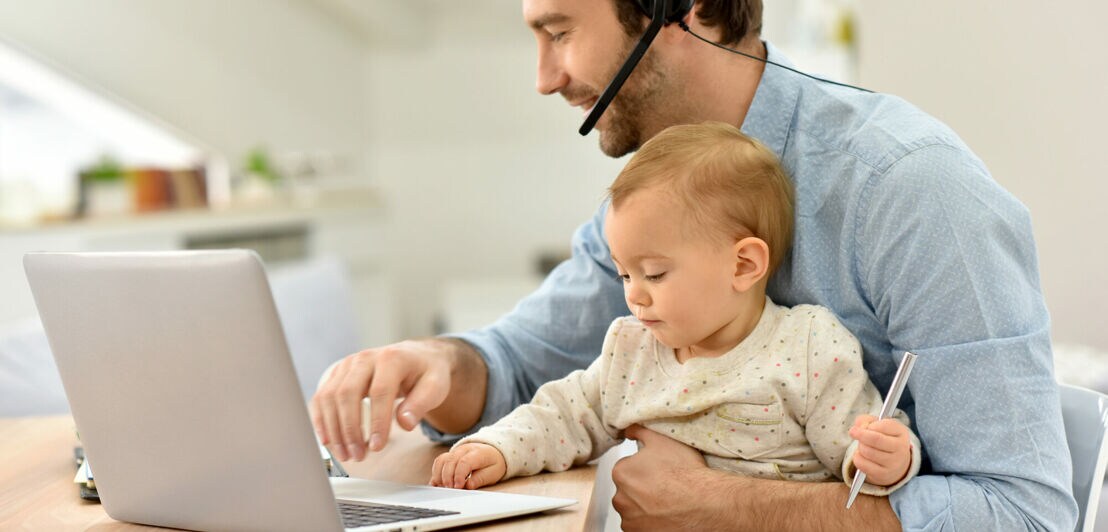 Busy businessman working from home and watching baby