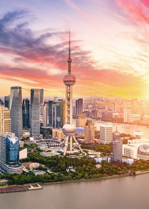 Skyline von Shanghai im Sonnenuntergang mit pinker Färbung am Himmel.