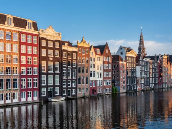 Häuser in verschiedenen Farben mit verzierten Giebeln und Fassaden am Kanal in Amsterdam