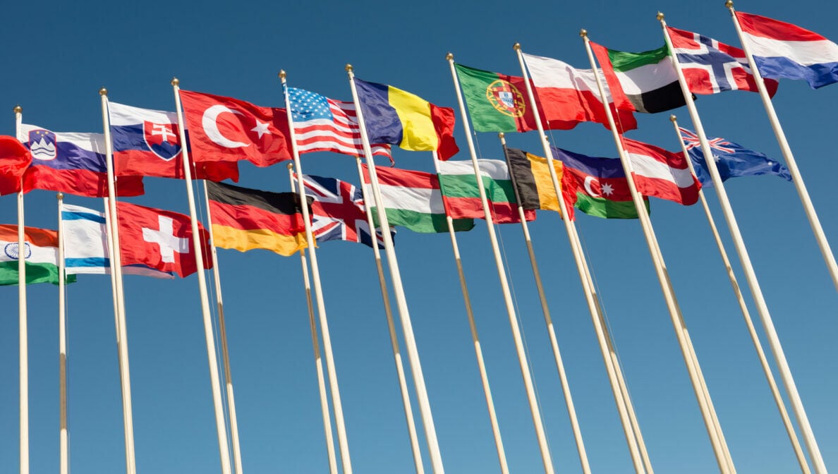 Zahlreiche Fahnenstangen, an denen die Flaggen verschiedener Nationen wehen.