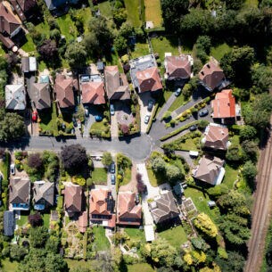 Luftaufnahme einer Sackgasse in einem Wohngebiet mit Einfamilienhäusern und Grünflächen.